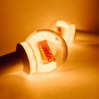 RIIZE Official Light Stick illuminated in orange